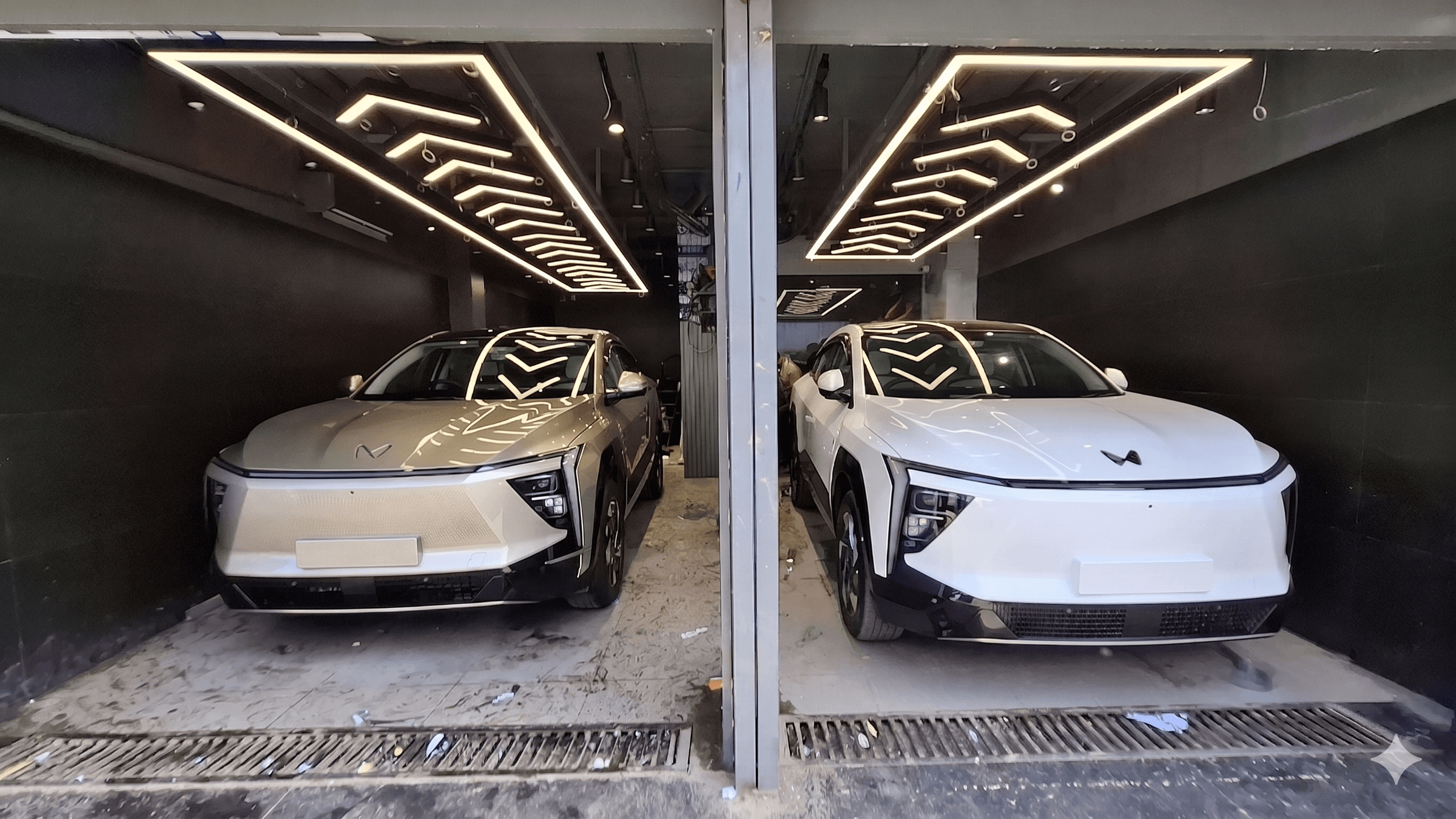 Two premium vehicles staged in the Shine My Ride studio bays